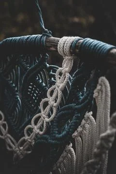 Panel of blue and white macrame on a decorative branch in nature Stock Photos