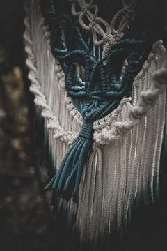 Panel of blue and white macrame on a decorative branch in nature Stock Photos