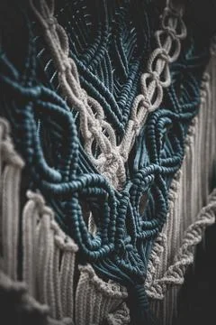 Panel of blue and white macrame on a decorative branch in nature Stock Photos