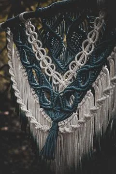 Panel of blue and white macrame on a decorative branch in nature Stock Photos