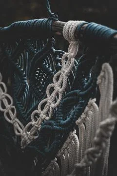 Panel of blue and white macrame on a decorative branch in nature Stock Photos
