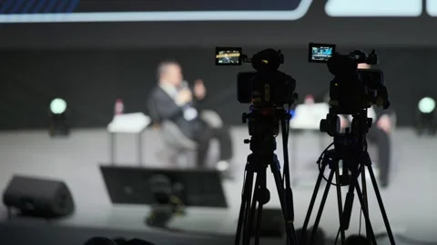 Panel discussion on stage with cameras recording interview in pr 库存影片 323433886