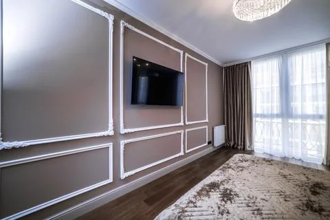 The panel is a plaster frame with patterned corners on the wall of the room.  Stockfoto's