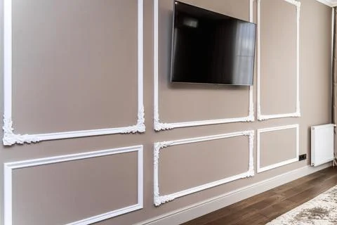 The panel is a plaster frame with patterned corners on the wall of the room.  Stockfoto's