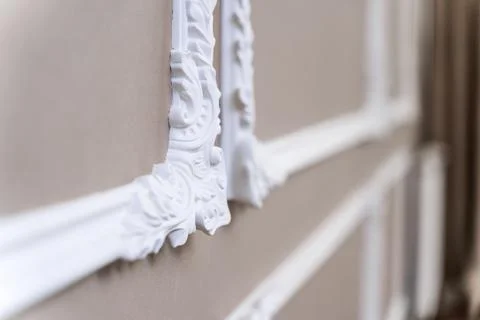 The panel is a plaster frame with patterned corners on the wall of the room.  Stockfoto's