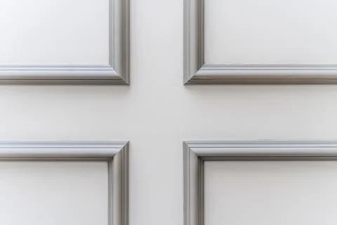 The panel is a plaster frame with patterned corners on the wall of the room.  Stock Photos