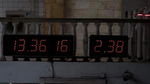 A panel timer with many orange neon bulbs in the subway in Moscow, Russia Stock Footage 312273605