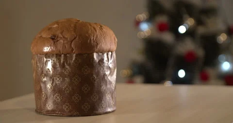 Panettone with blurry Christmas lights blinking in the background. Panettone con Stock Footage 160862229