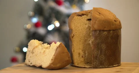 Panettone slice with Christmas tree and blurry lights flashing Video stock 160626287
