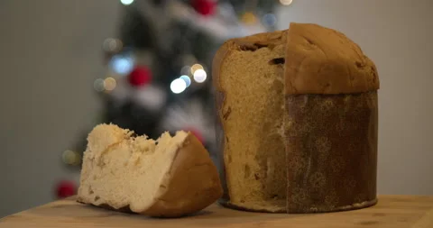 Panettone slice with Christmas tree and blurry lights flashing in the backgroun Video stock 160626381