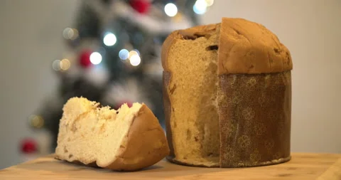 Panettone slice with Christmas tree and blurry lights flashing Video stock 160626650