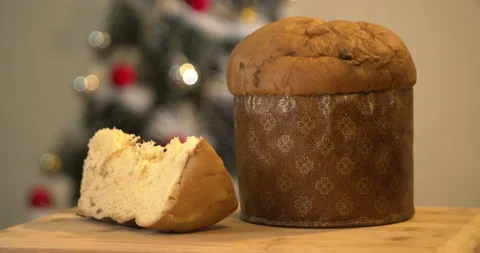Panettone slice with Christmas tree and blurry lights flashing Video stock 160627604