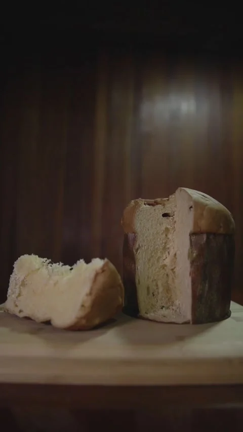 Panettone slice on the table. Panettone cut on wooden table and textured backgro Stock Footage 160772317