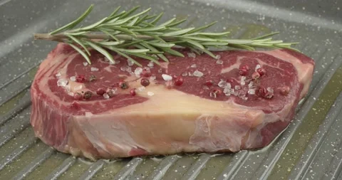Panfrying a beefsteak in a griddle pan closeup Stock Footage 141060147