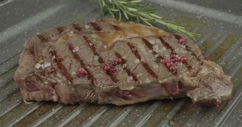 Panfrying a beefsteak in a griddle pan closeup Stock Footage 148264564