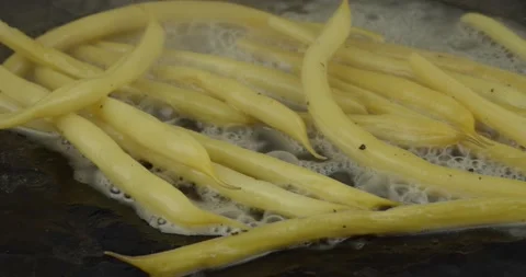 Panfrying yellow string beans closeup Stock Footage 140521599