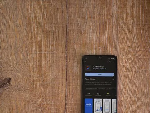 Pango app play store page on smartphone on wooden background Stock Photos