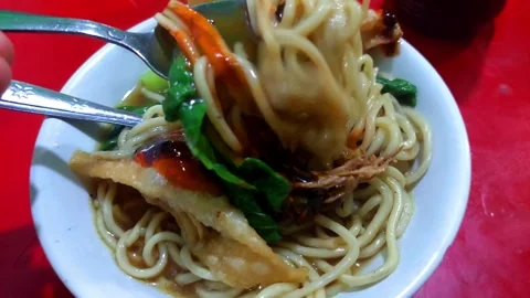 Pangsip noodles on the table and a pair of spoons and forks Stock Footage 265253936