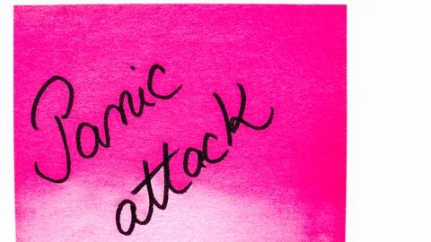 Panic attack handwriting text close up isolated on pink paper with copy spa.. Stock Photos