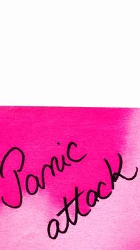 Panic attack handwriting text close up isolated on pink paper with copy spa.. Stock Photos