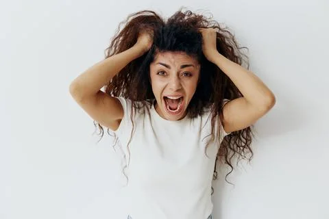 Panic Attack PROBLEMS CONCEPT. Crazy beautiful Latin female with afro rips out Stock Photos