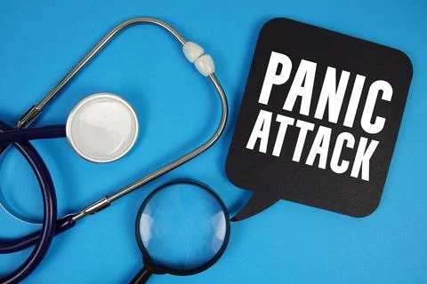 Panic Attack text with Stethoscope and magnifying glass on blue background Stock Photos