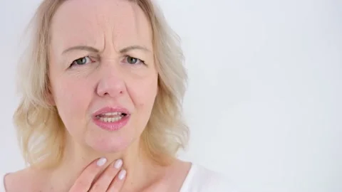 Panic attack woman holds hand on chest touches throat with fingers sore throat Stock Footage 236509083