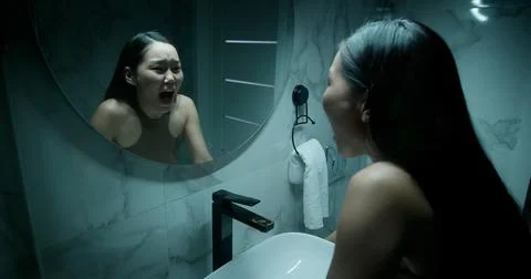 Panic attack, Woman look mirror. Mental health struggle. Nervous breakdown. Stock Photos