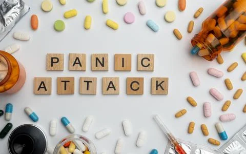 Panic attack word on wooden blocks with prescription pill bottles and pills.. Stock Photos