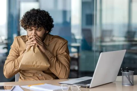 Panic attack in worker inside office at workplace, businessman breathing hard Stock Photos