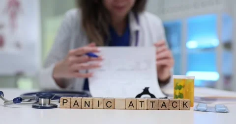 Panic Attack written with blocks lies beside documents on desk Stock Footage 314107867