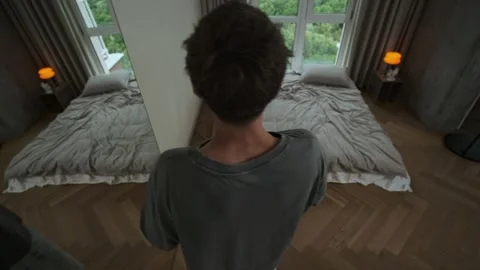 Panic attack. A young man breathes heavily and moves anxiously, struggling with Stock Footage 312327089