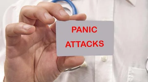 Panic attacks the text on the card of a man in a white shirt Stock Photos