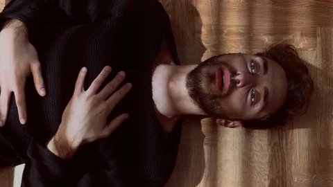 Panic attack.Young man anxious and stressed lying on the floor in the dark Stock Footage 86331400