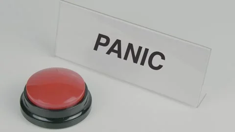 Panic text or word displayed on a nameplate as a hand presses a red button Stock Footage 307197316