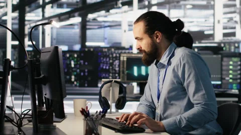 Panicked engineers in data center reacting to ransomware warning on PC Stock Footage 309779836
