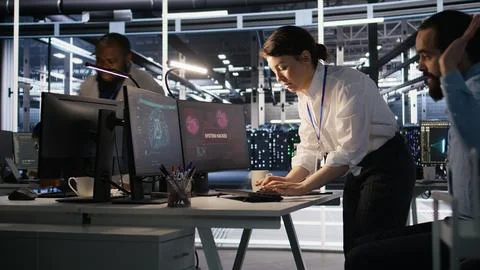 Panicked engineers in data center reacting to ransomware warning on PC Stock Photos