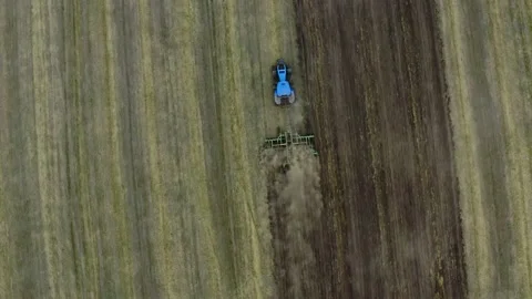 Paning Aerial view over the tractor plows the land in the village. The proces Stock-Footage 137263687