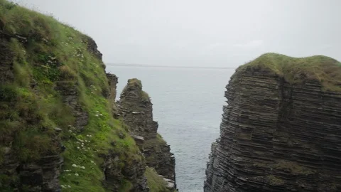 Paning out across the cliffs and sea at Castle ruins Stock Footage 111537139