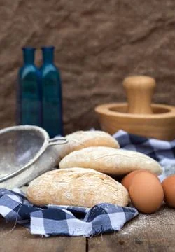 Panini rolls in rustic kitchen setting with cooking utensils Stock Photos