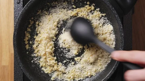 Panko and chopped nuts toast together in frying pan for coating. Stock Footage 342438245