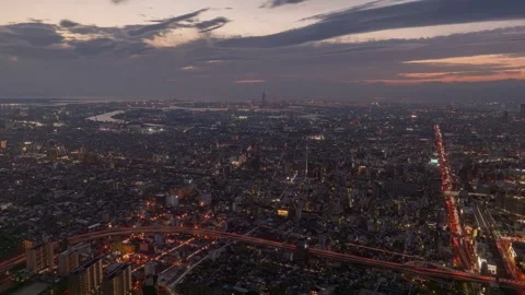 PanLeft Sunset Timelapse of Osaka Cityscape Transitioning from Day to Night Stock Footage 326296328