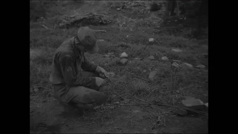 PANMUNJOM - 1953 - UN engineers roll a coil of wire and hook it into a trailer Stock Footage 337709953