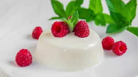Panna cotta with raspberry, decorated with fresh mint. Stock Footage 99747783