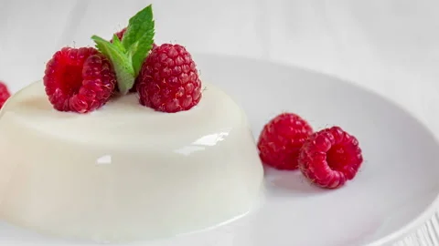Panna cotta with raspberry, decorated with fresh mint. Stock Footage 99747962