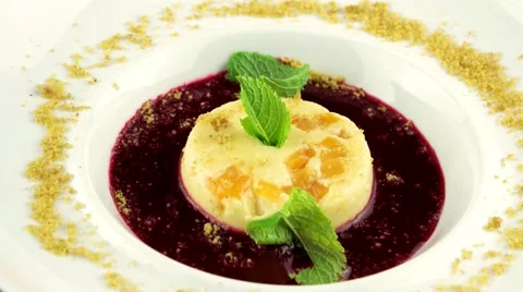 Panna cotta with raspberry sauce and fresh mint in white plate, loop Stock Footage 66482504