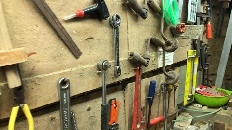 Panning accross home handyman workshop tools on wall Stock Footage 127828705