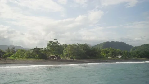 Panning across beach and view of island from the water in Bali Indonesia Stock Footage 144200622