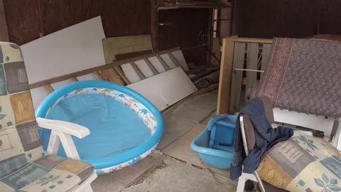 Panning across cluttered storage room in messy garage Stock Footage 113046500