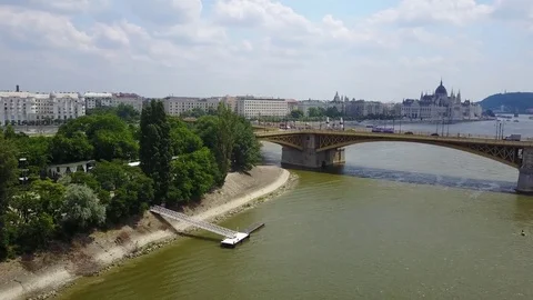 Panning across Danube River in Budapest, Hungary with parliament and bridge Stock Footage 77109961
